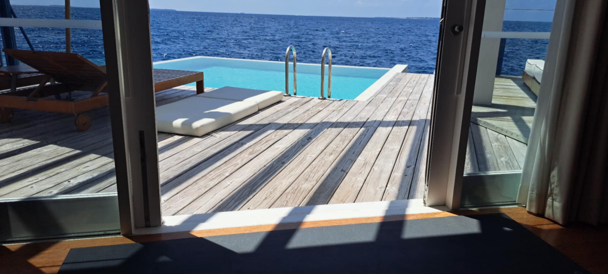 Luxury overwater villa with infinity pool at Amilla Maldives Resort where Karol Krauser served as visiting wellness practitioner